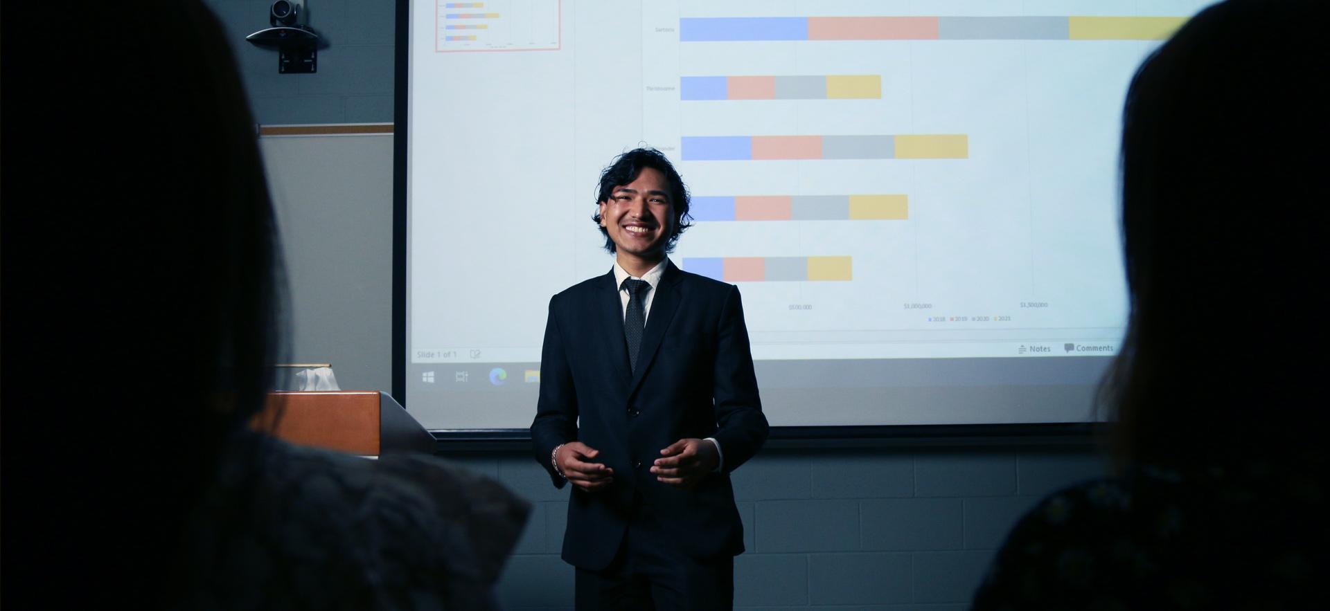 Business student at front of class doing a presentation