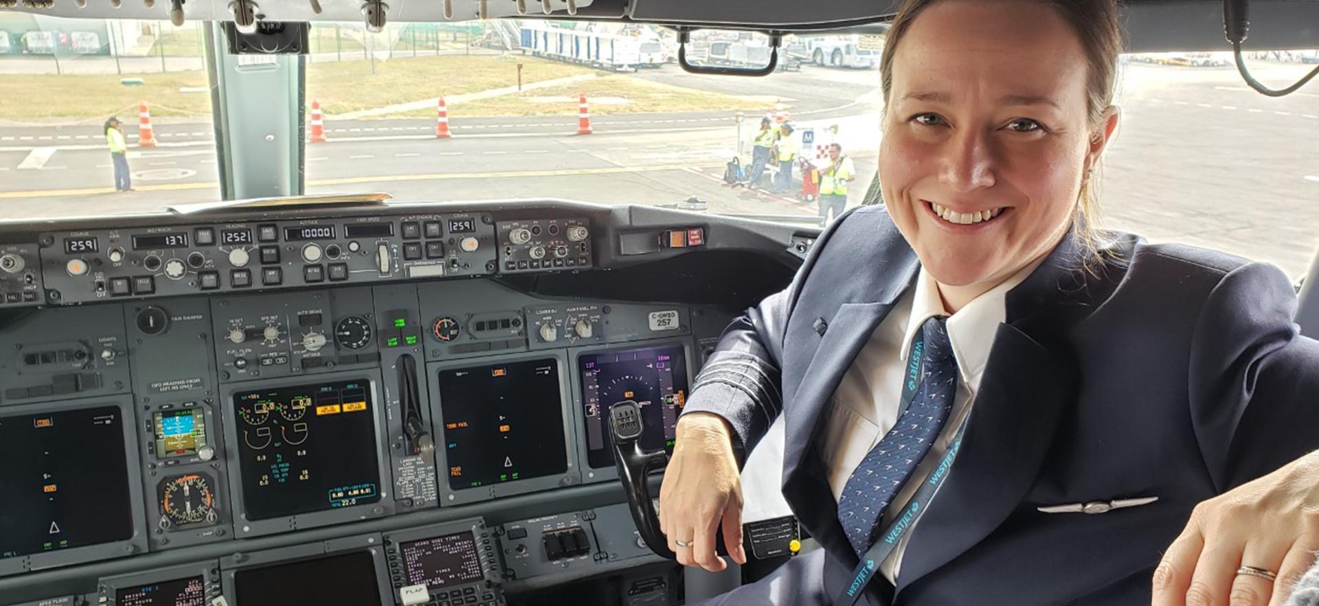 Stacey a graduate of Aviation Technology - Flight shown in a cockpit of a plane