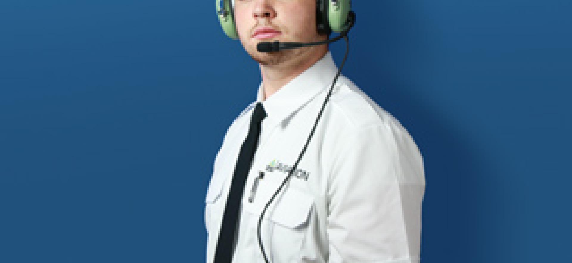 Aviation student in uniform and with headset looking at camera with text overlay YOUR TIME TO BE SOARING