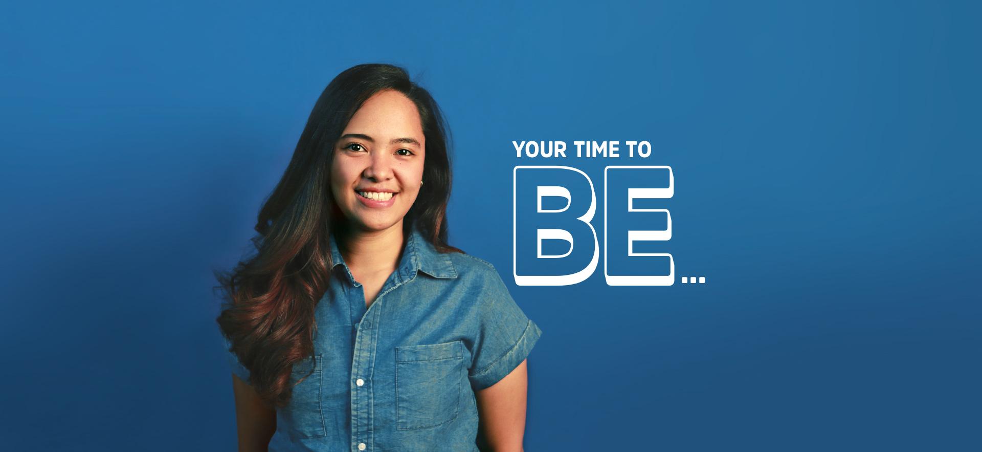 YOUR TIME TO BE text overlay beside student smiling at camera with blue background