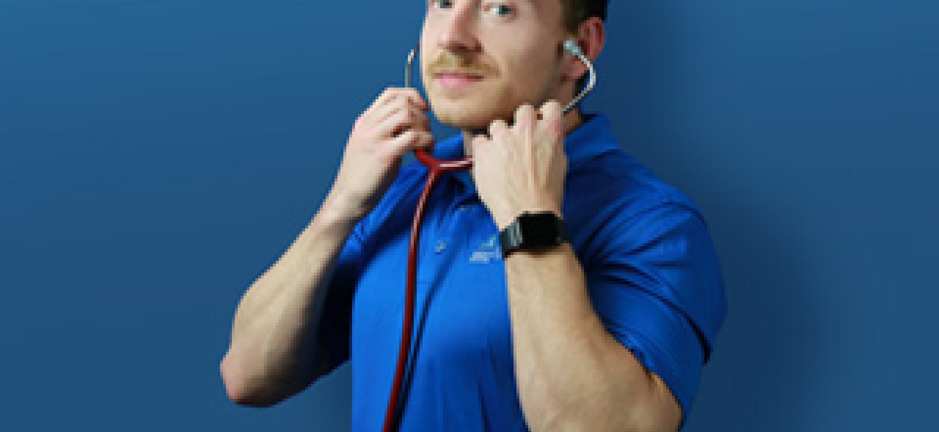 Nursing student in uniform with stethoscope on with blue background and text YOUR TIME TO BE CARING