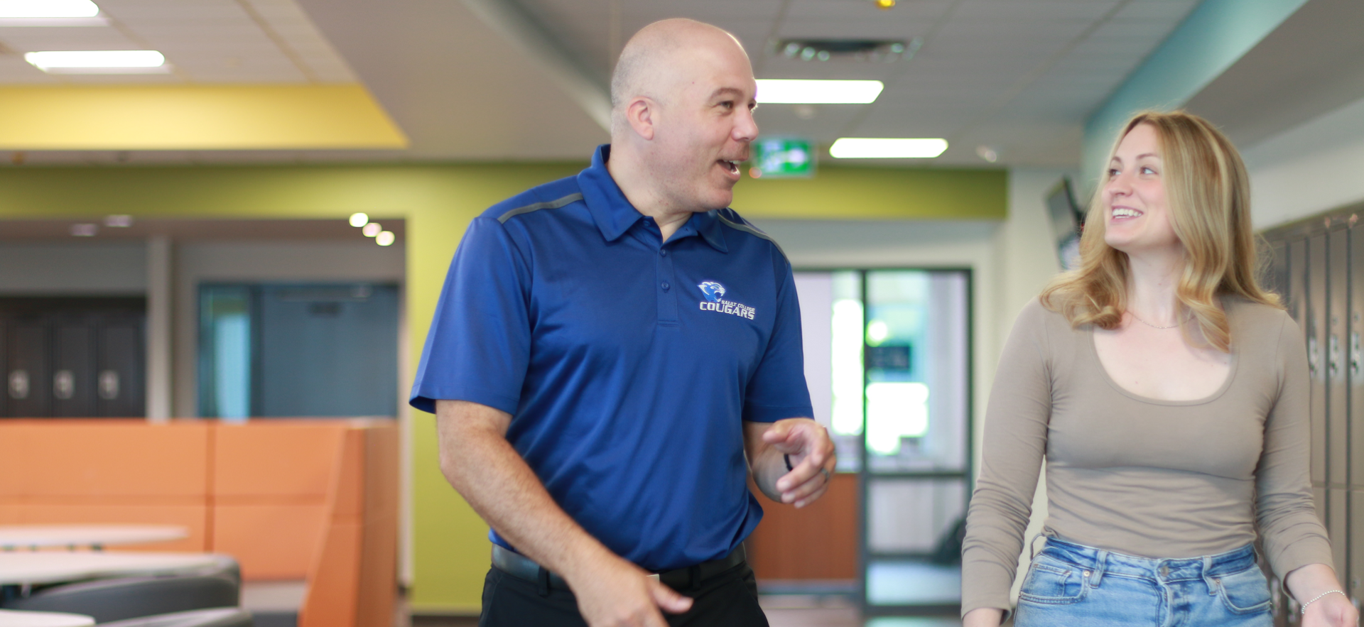 Recruiter chatting with prospective student while giving a tour of campus