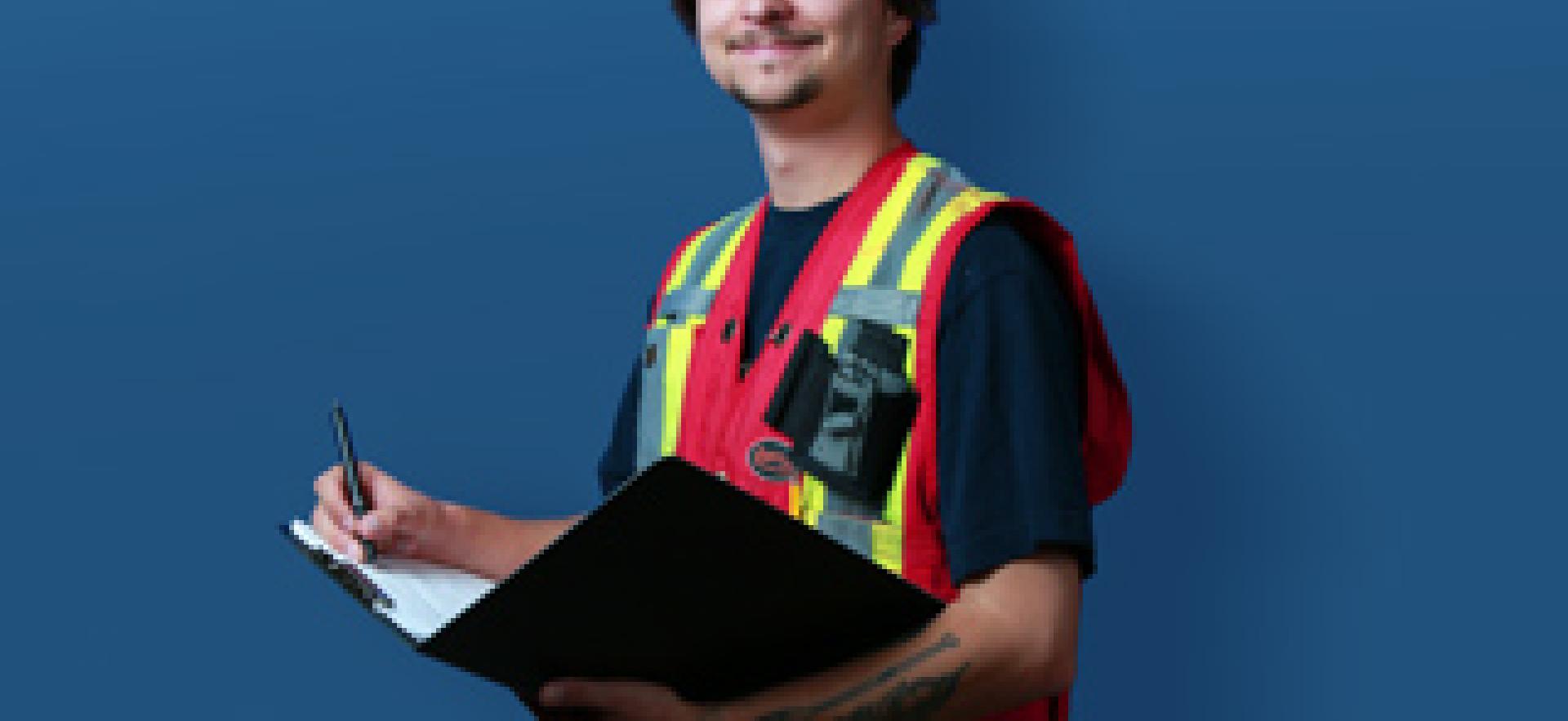 School of Natural Environment Student wearing safety vest, hard hat and looking at camera with text over blue background YOUR TIME TO BE OUTDOORS