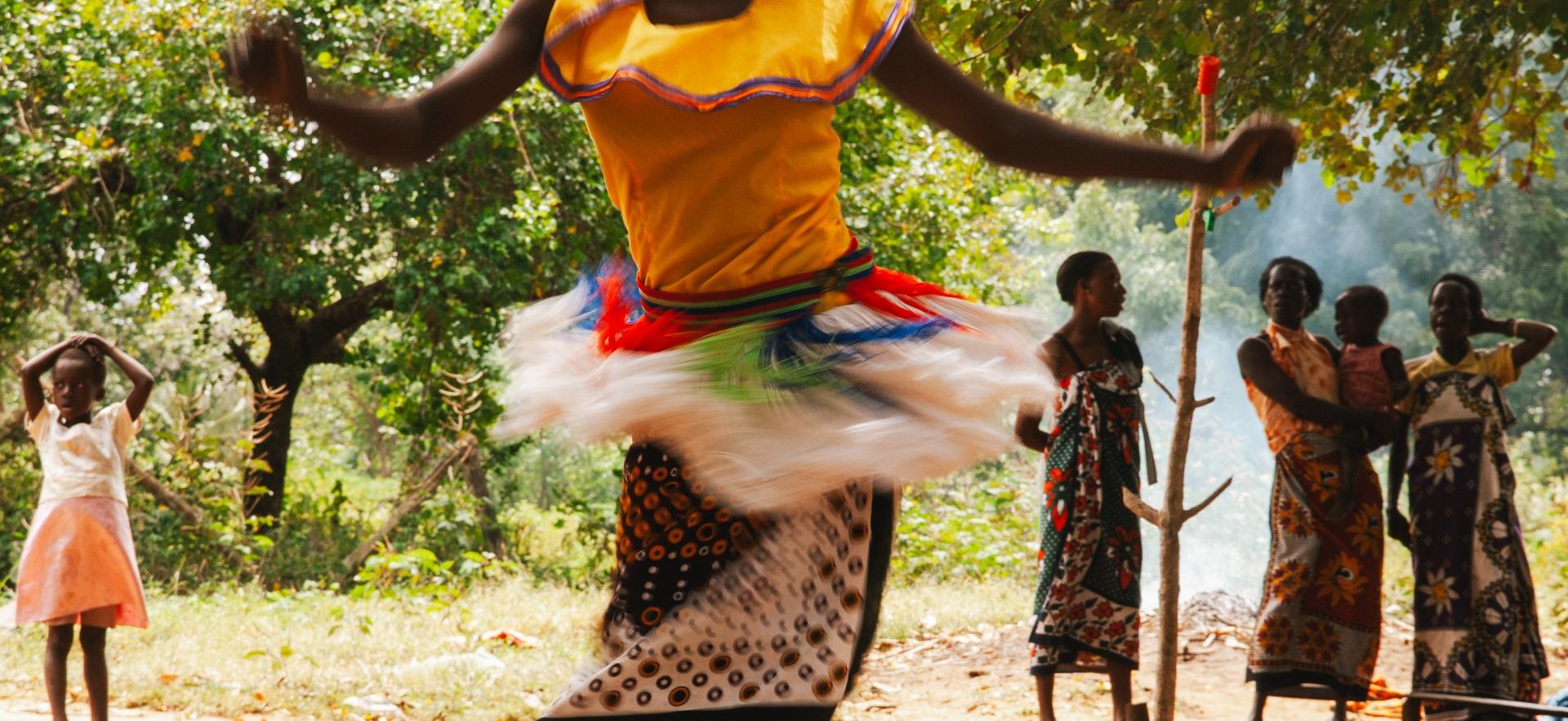 Jess' photo of woman dancing with skirt in motion and people in background