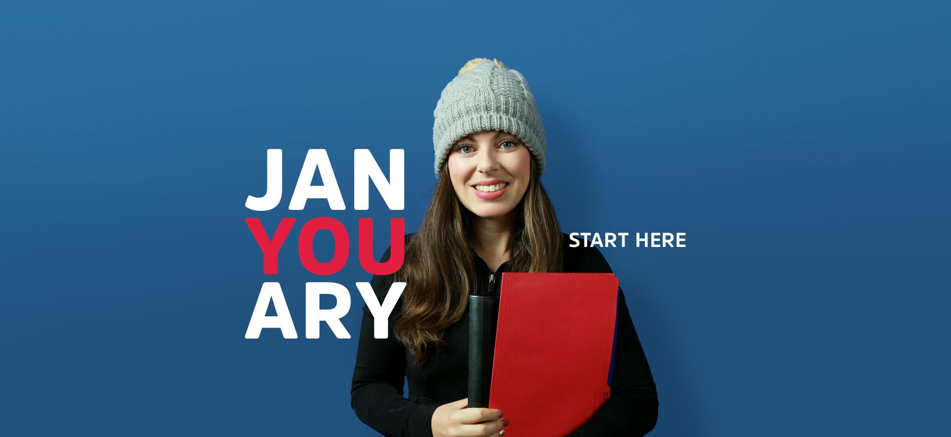 January Starts student holding folder wearing knit tuque