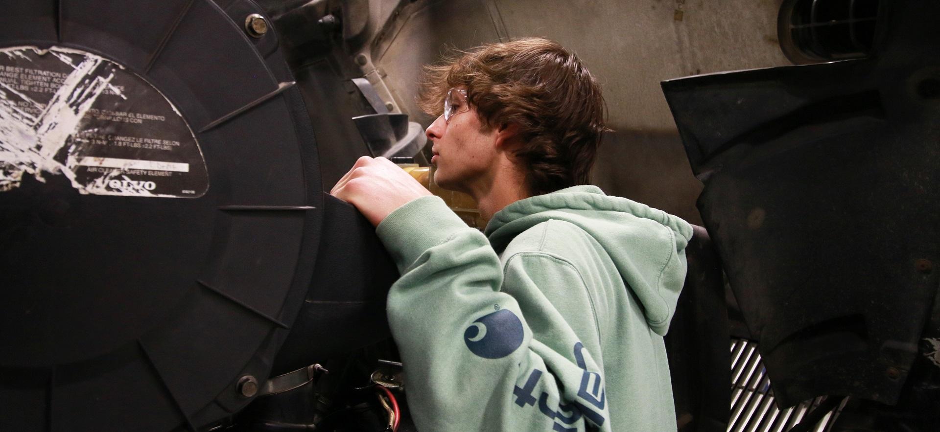 Heavy Equipment student looking at vehicle