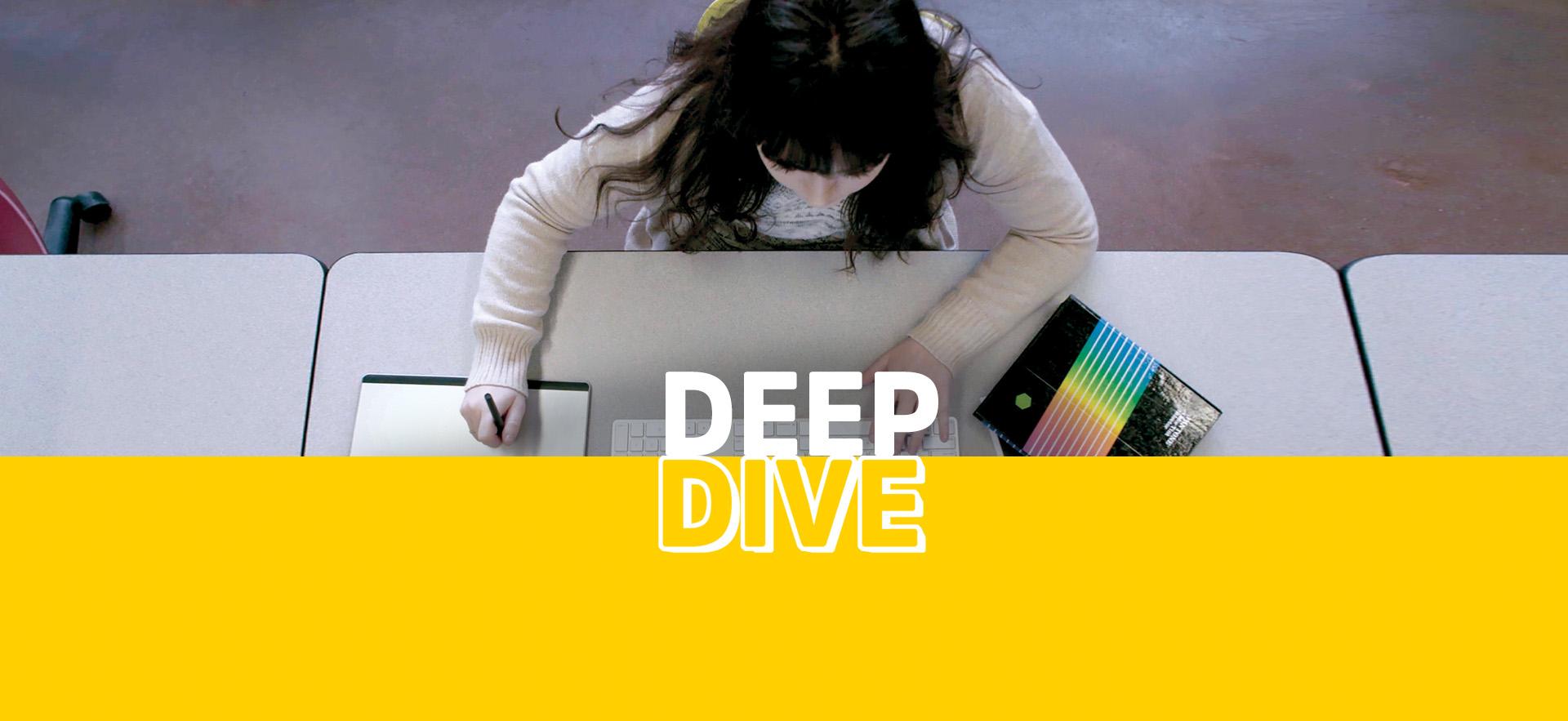 Deep Dive Media and Design student working on computer