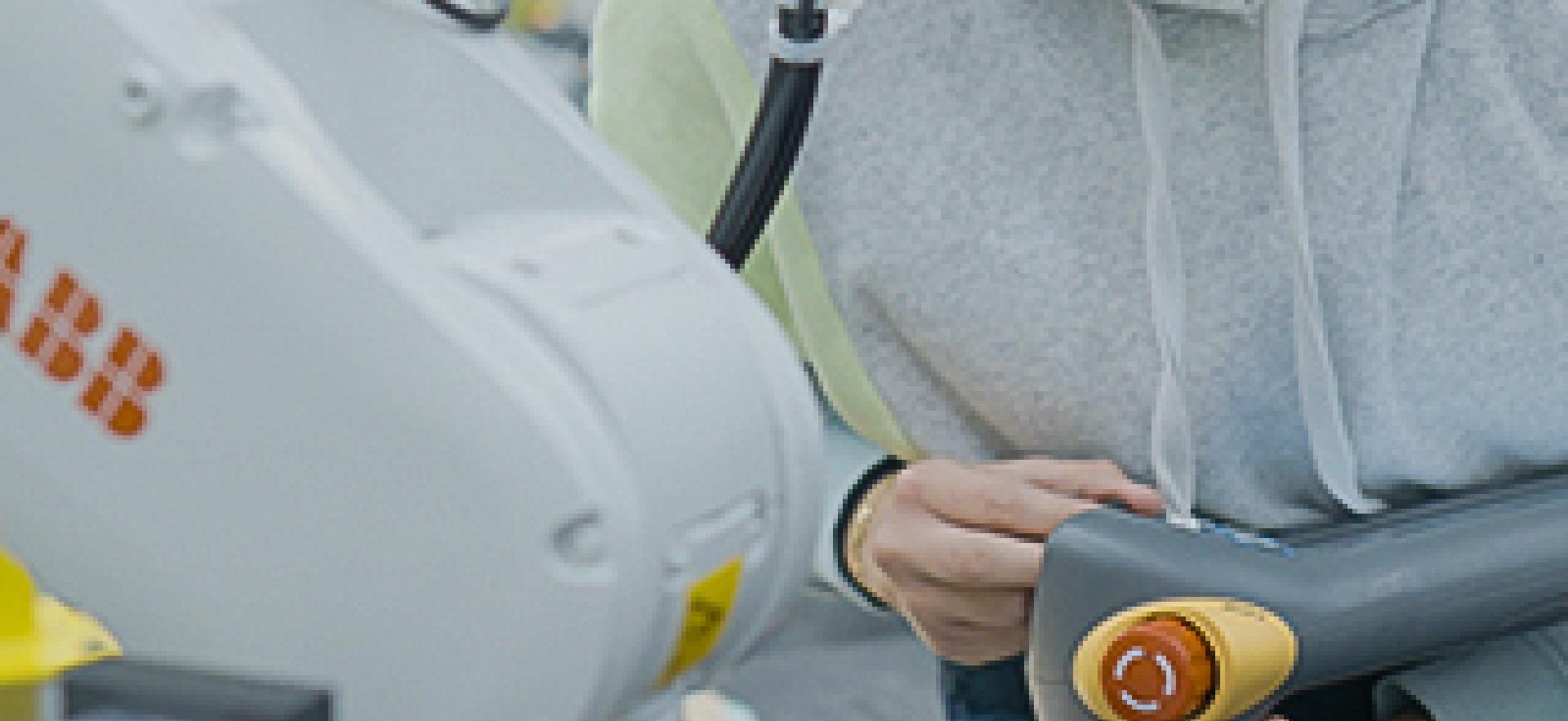 Engineering student working with a robot arm in the robotics lab