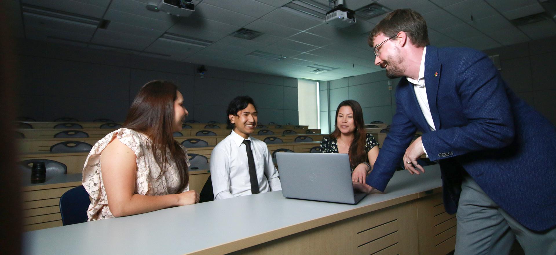 Instructor with students in Multi Media Centre