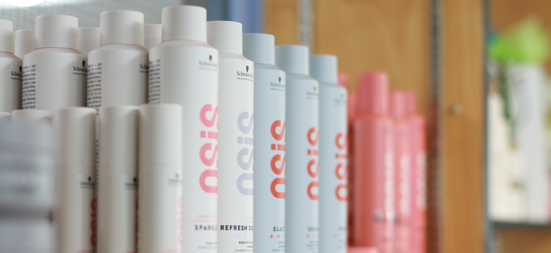 Hair salon products lined up on a shelf