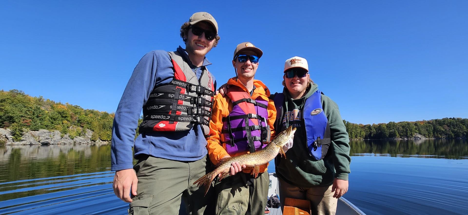 Fish and Wildlife students posing on a boat with fish they caught