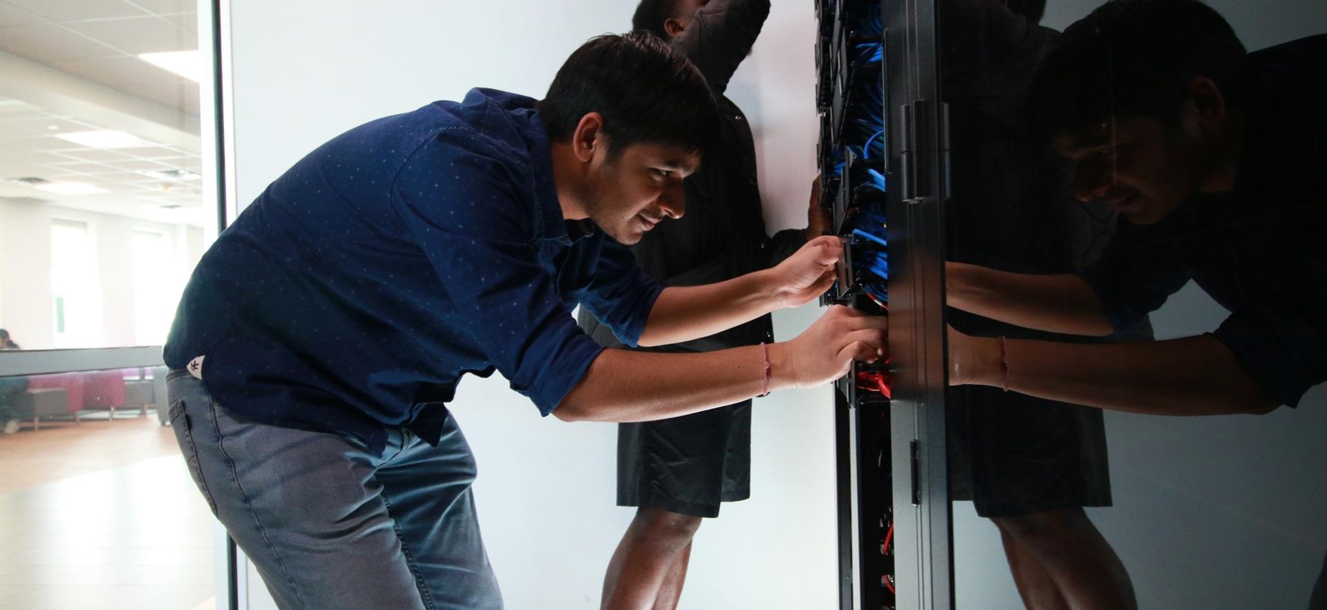 IT student Nitesh working in server room