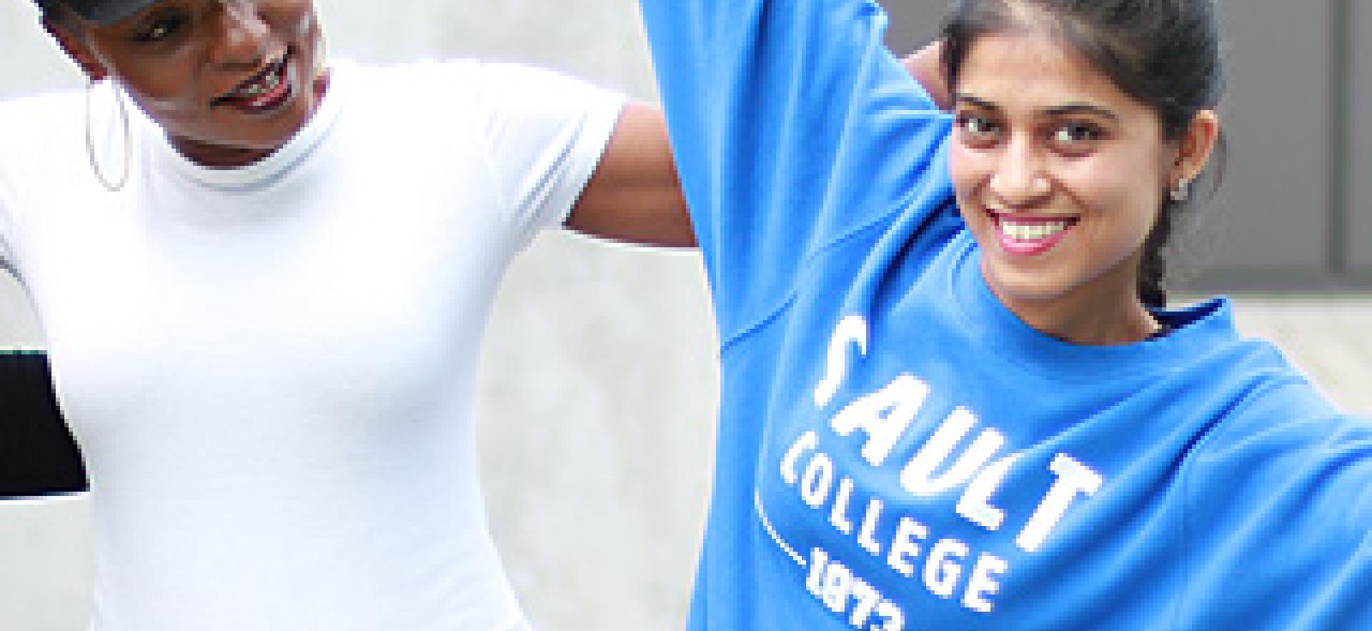 Two students having fun outside on campus