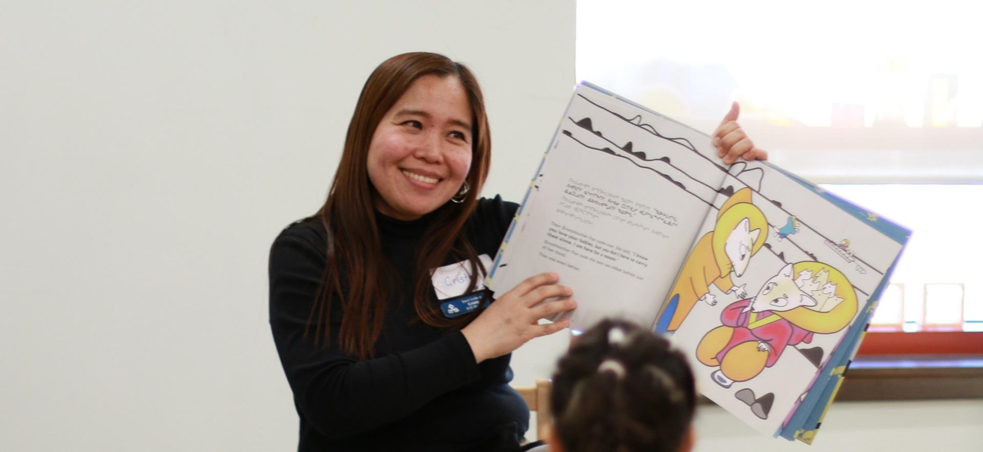 ECE student reading a story to children