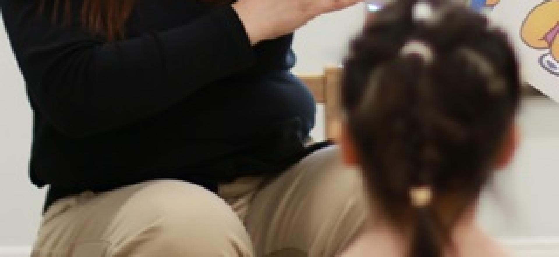 ECE student reading a story to children