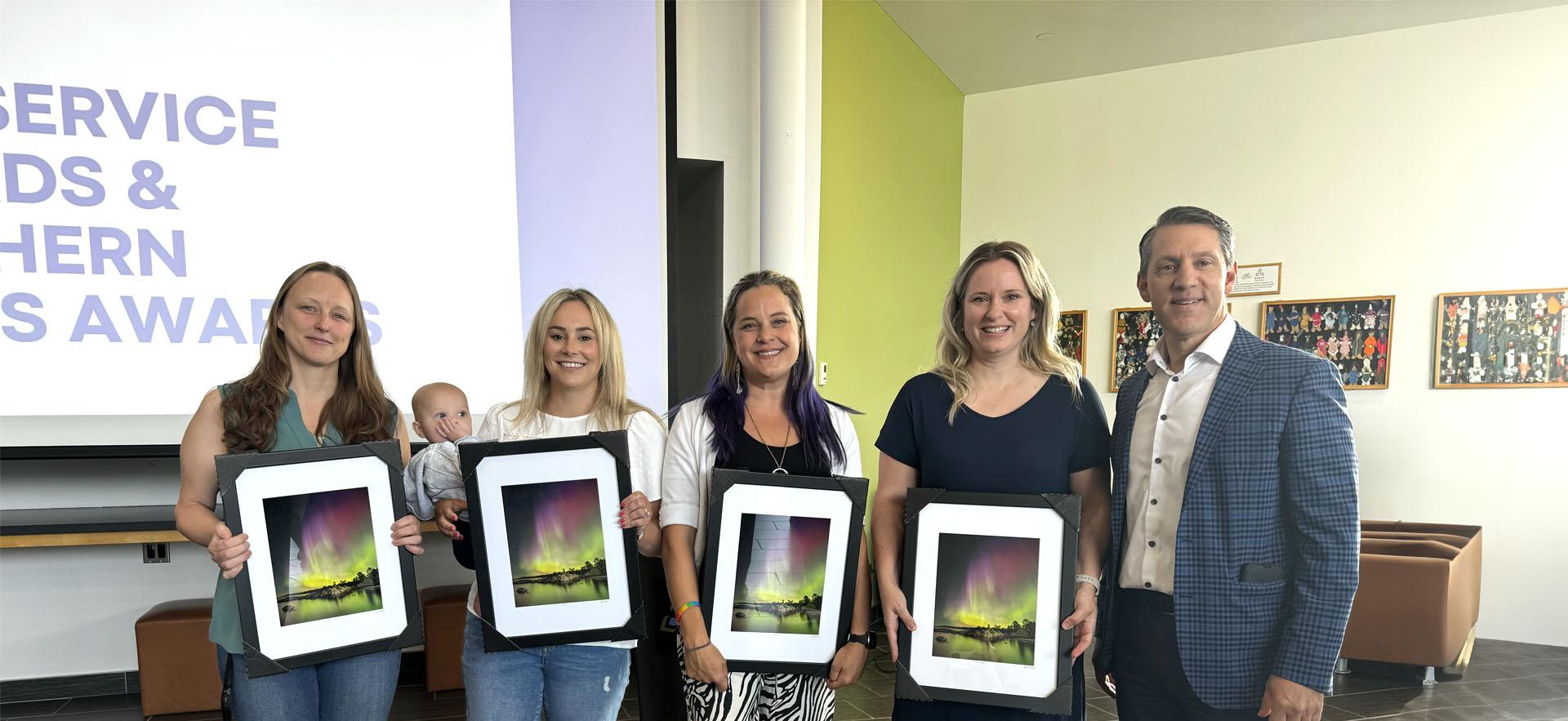 Image of Staff with awards with President