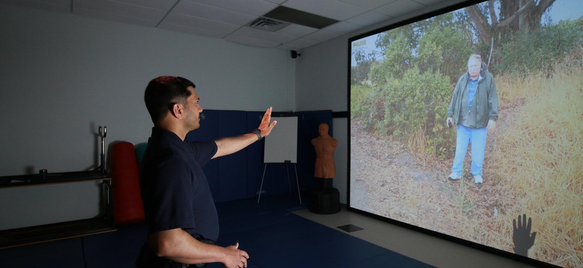 Policing student in the sim lab interacting with simulation scenario on screen