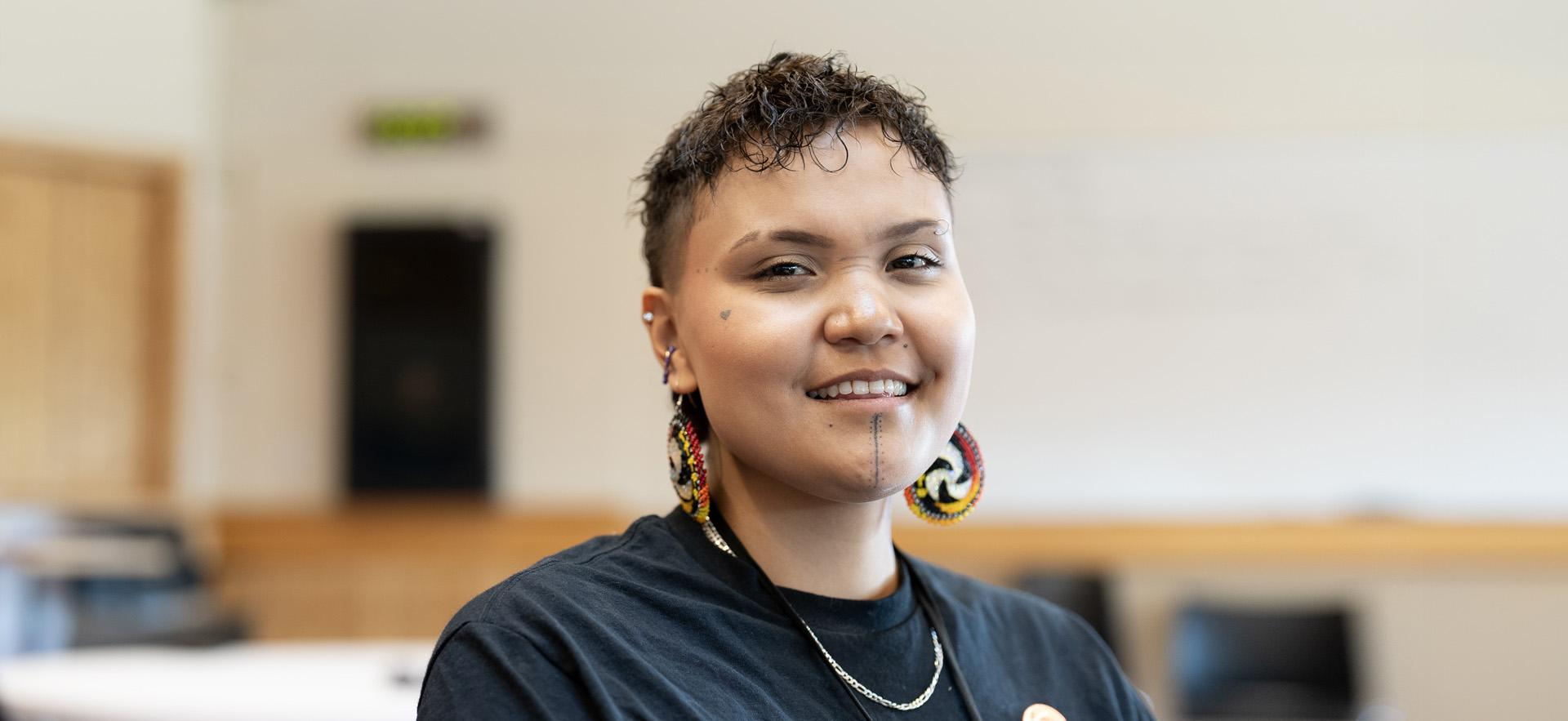 Indigenous Studies student sitting and smiling at the camera