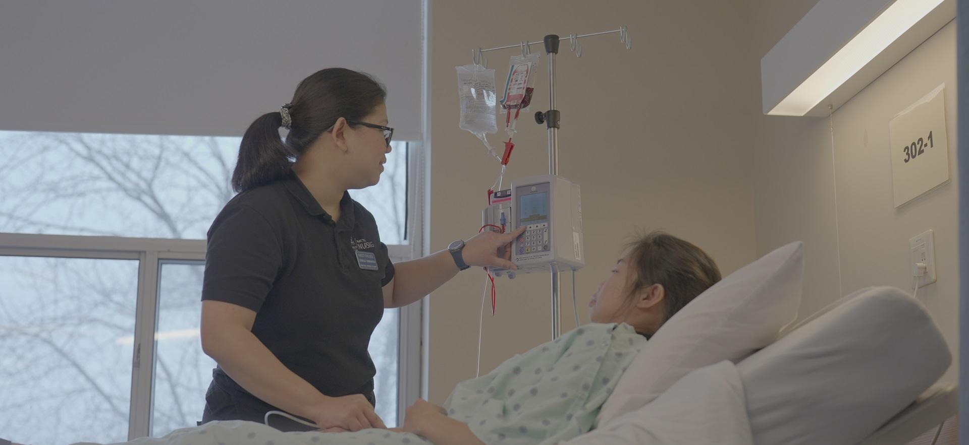 Nursing student in lab practicing vitals and IV with a classmate as patient