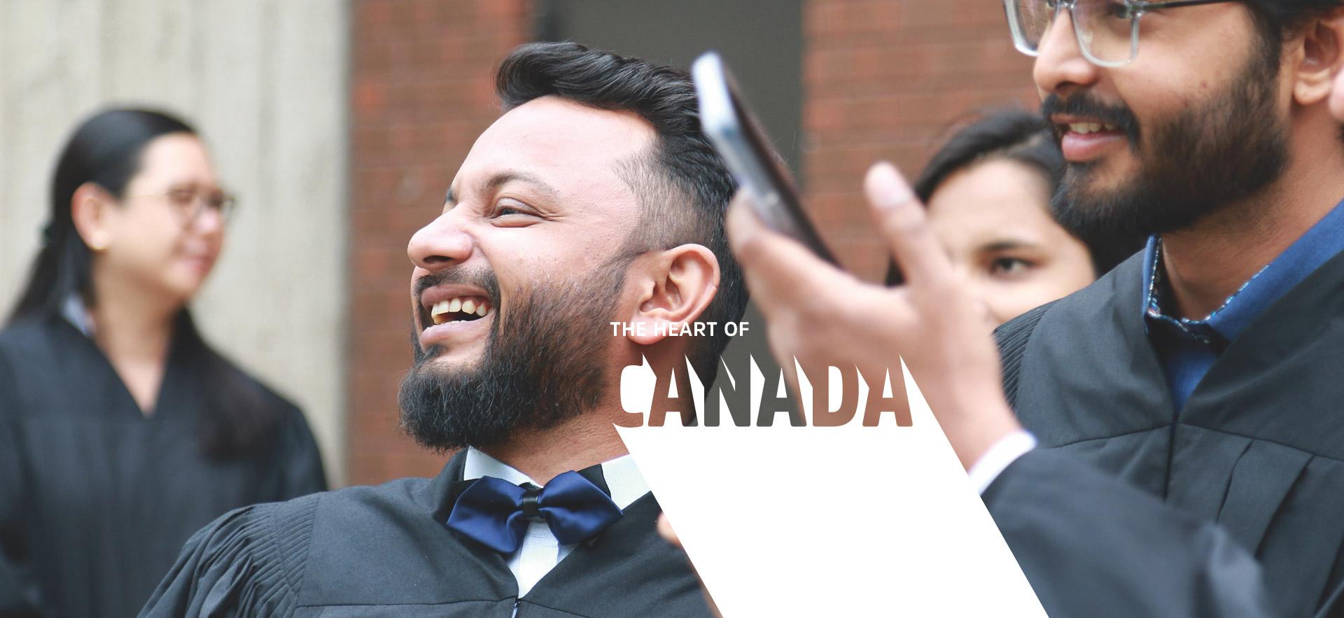 international student graduate smiling in grad gown 