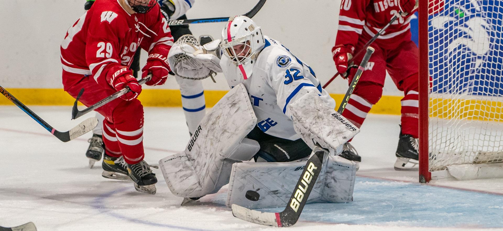 Men's Hockey goalie stopping stop from entering net