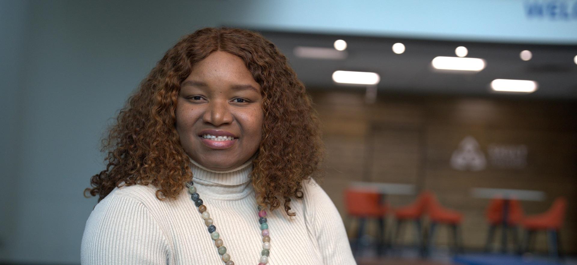 International student posed and smiling at the camera