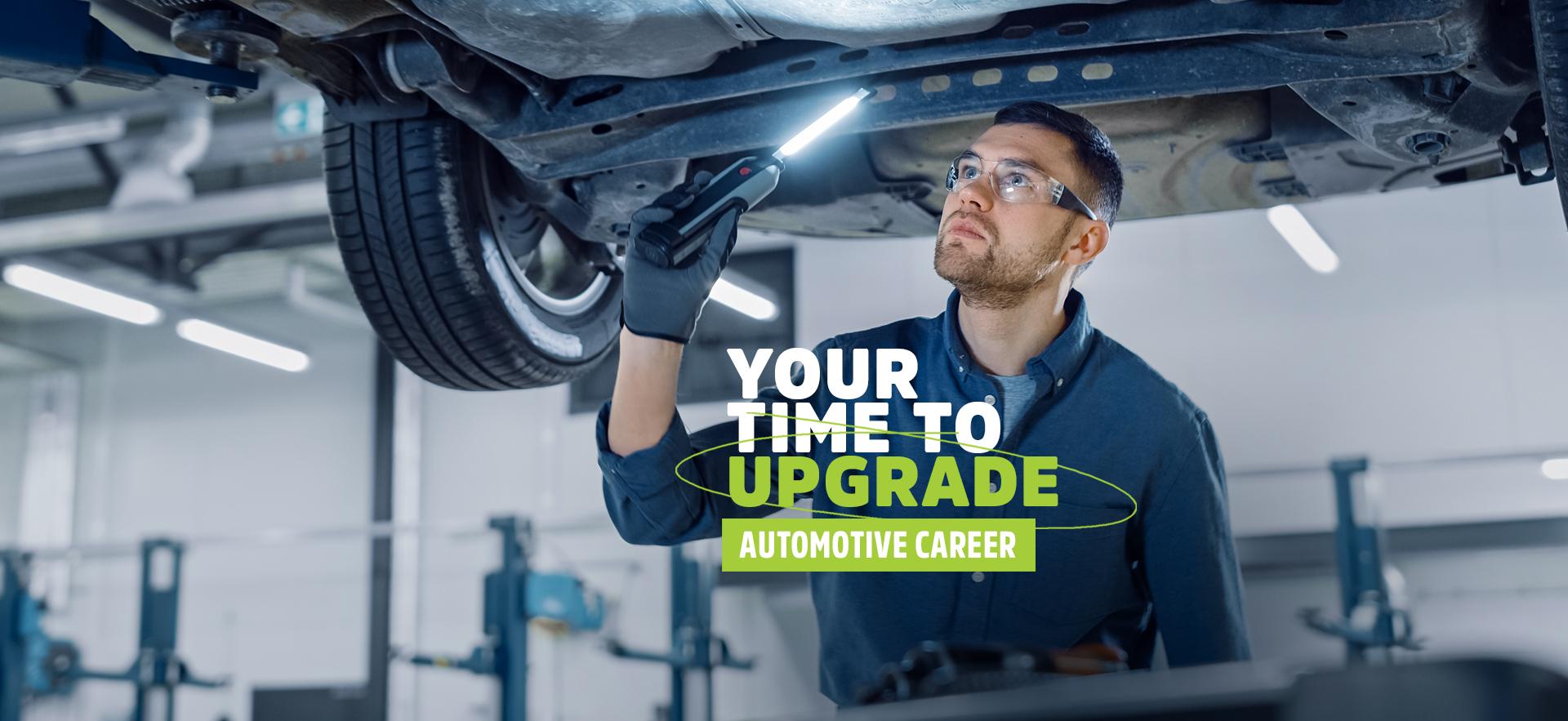 Man under lifted car diagnosing problem