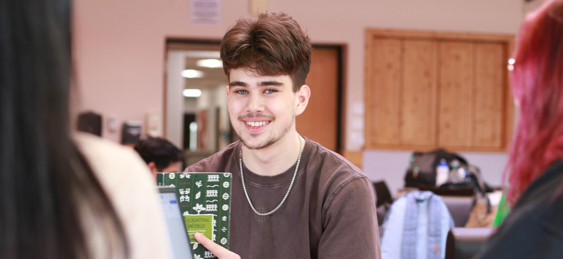 Student smiling at camera sitting in Enji