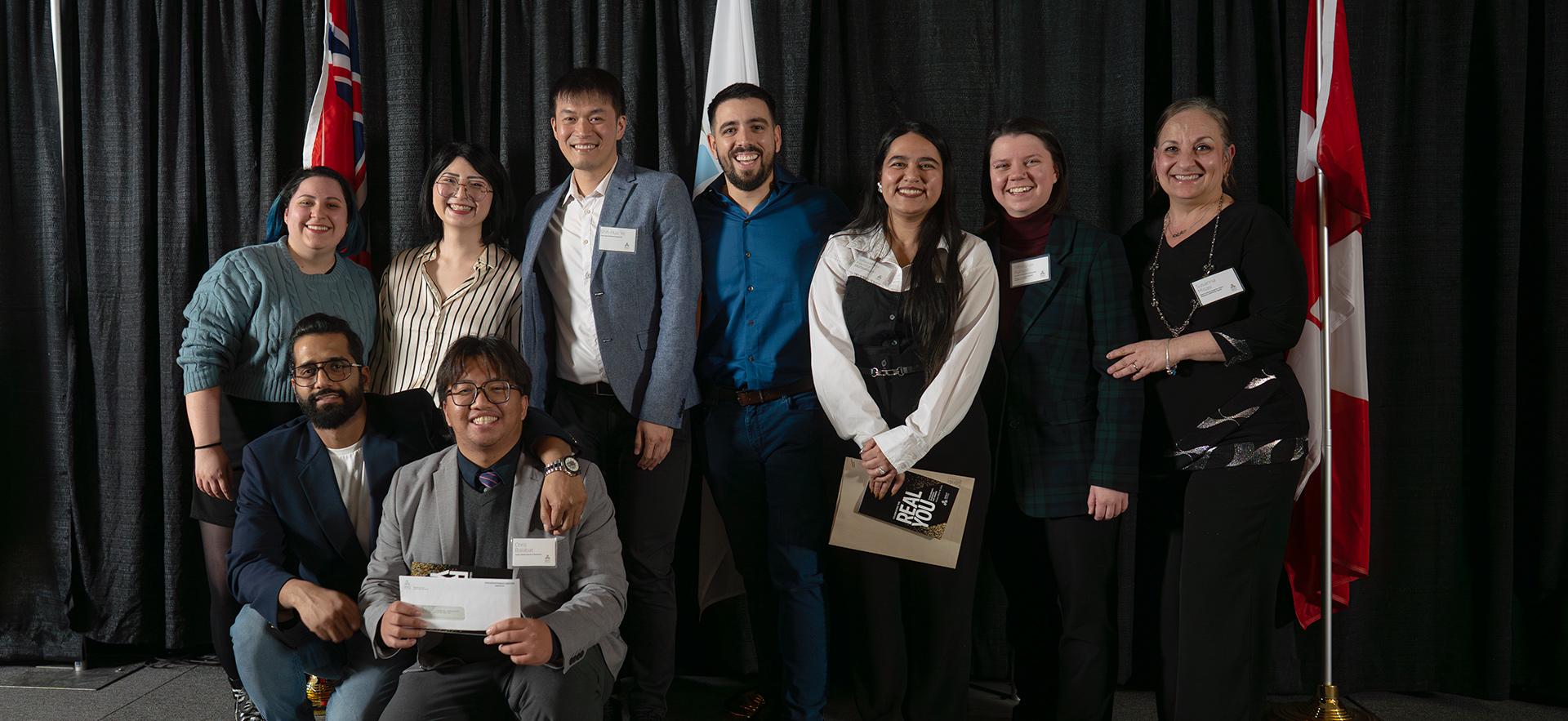Group of students posing together with their awards