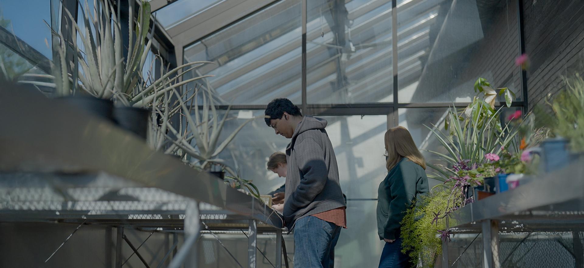 CICE students in the SONE greenhouse with a learning specialist