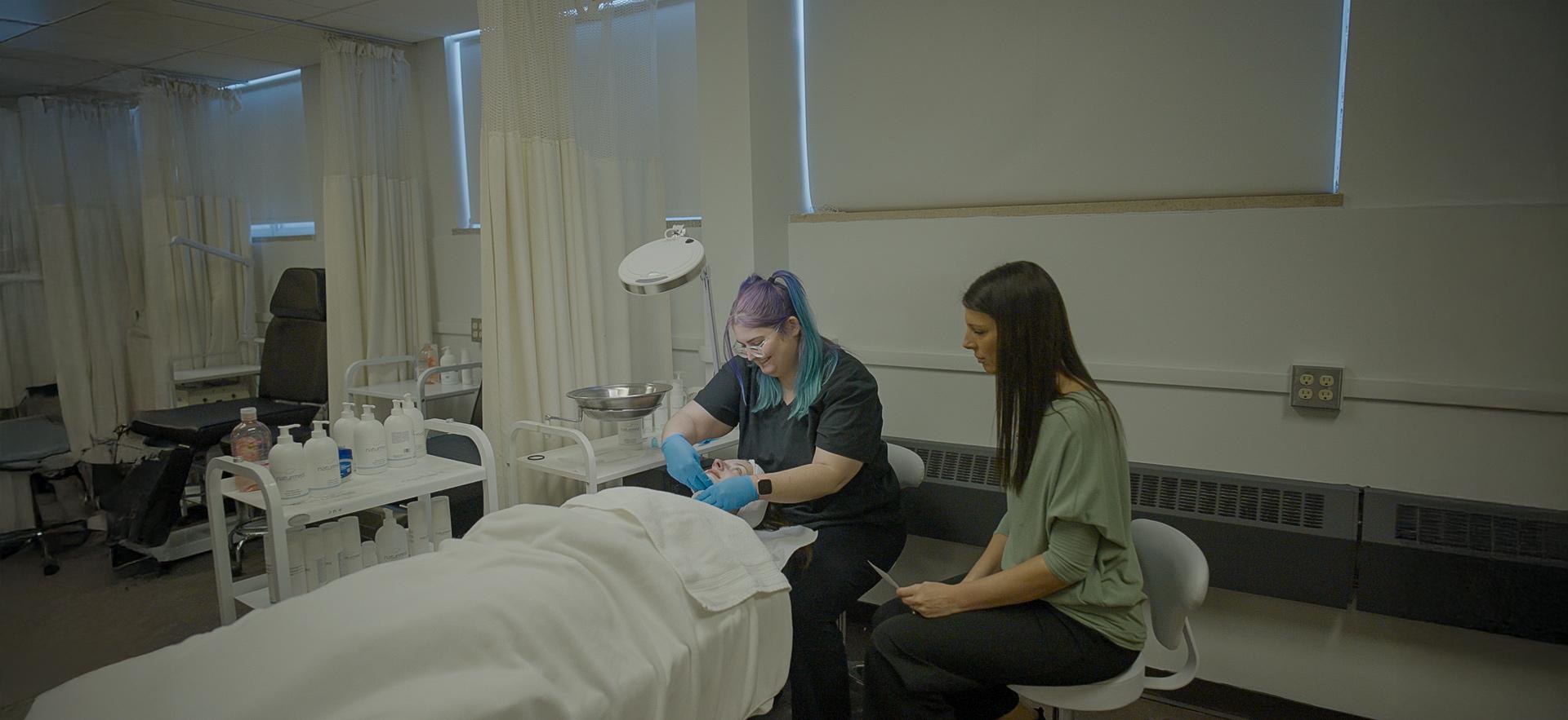 CICE student completing a facial in the spa with CICE staff 