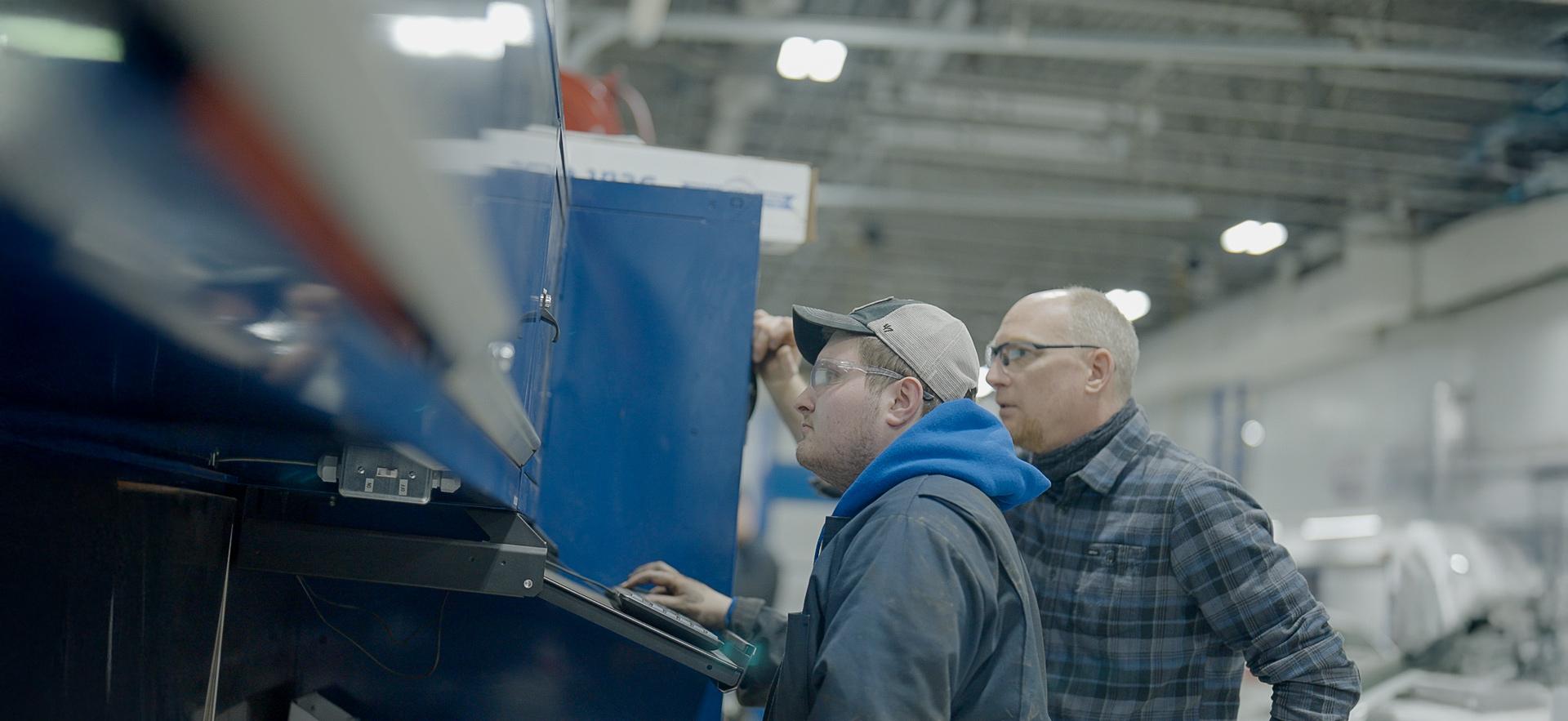 CICE student with learning specialist working in the motive power centre