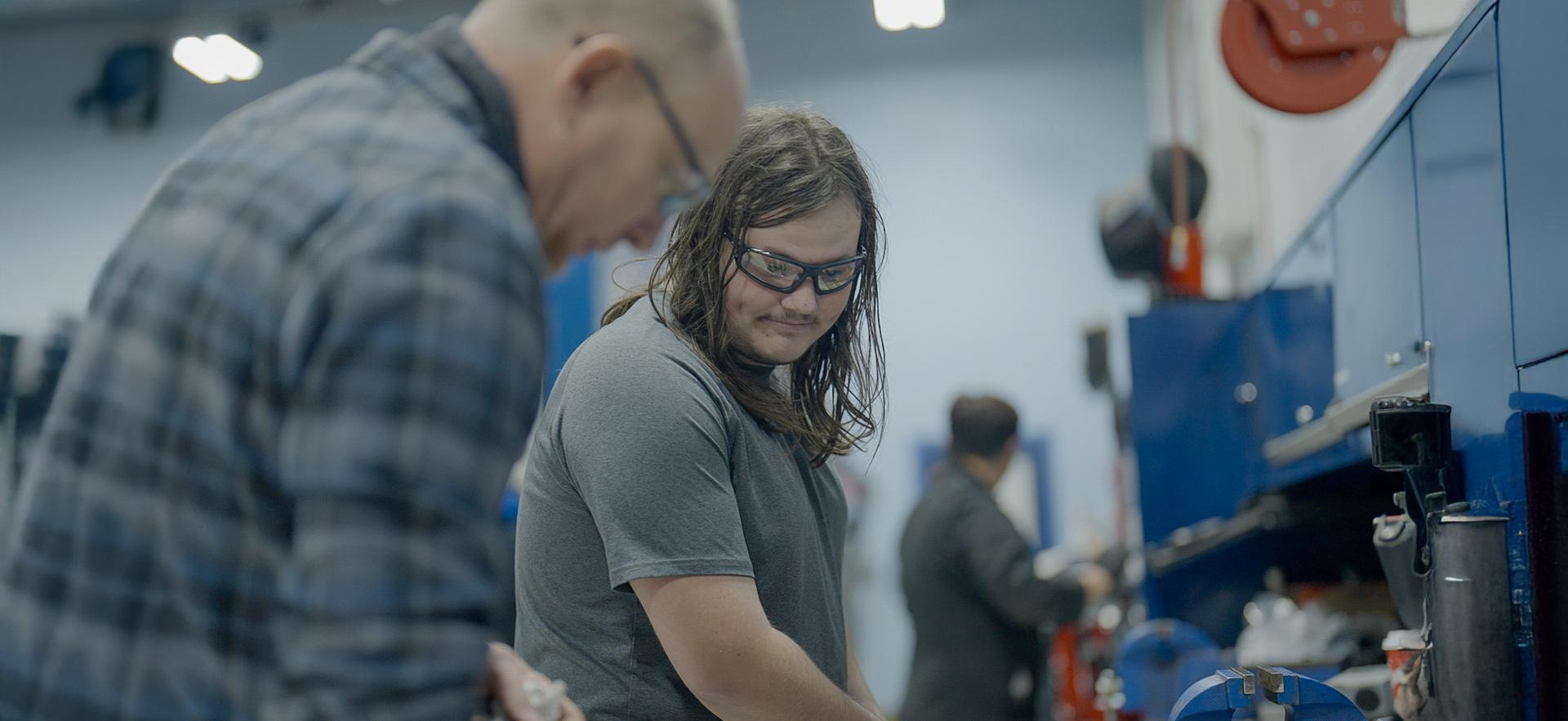 CICE student with a learning specialist working in the motive power centre