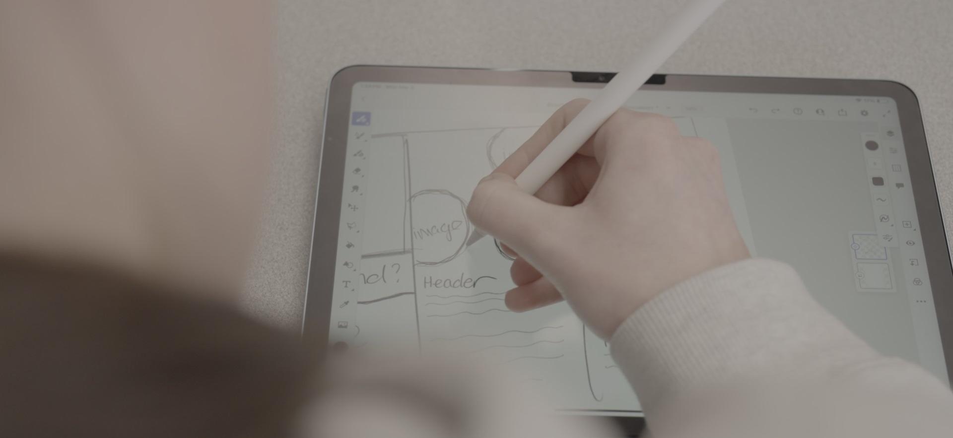 Graphic Design student sketching on iPad