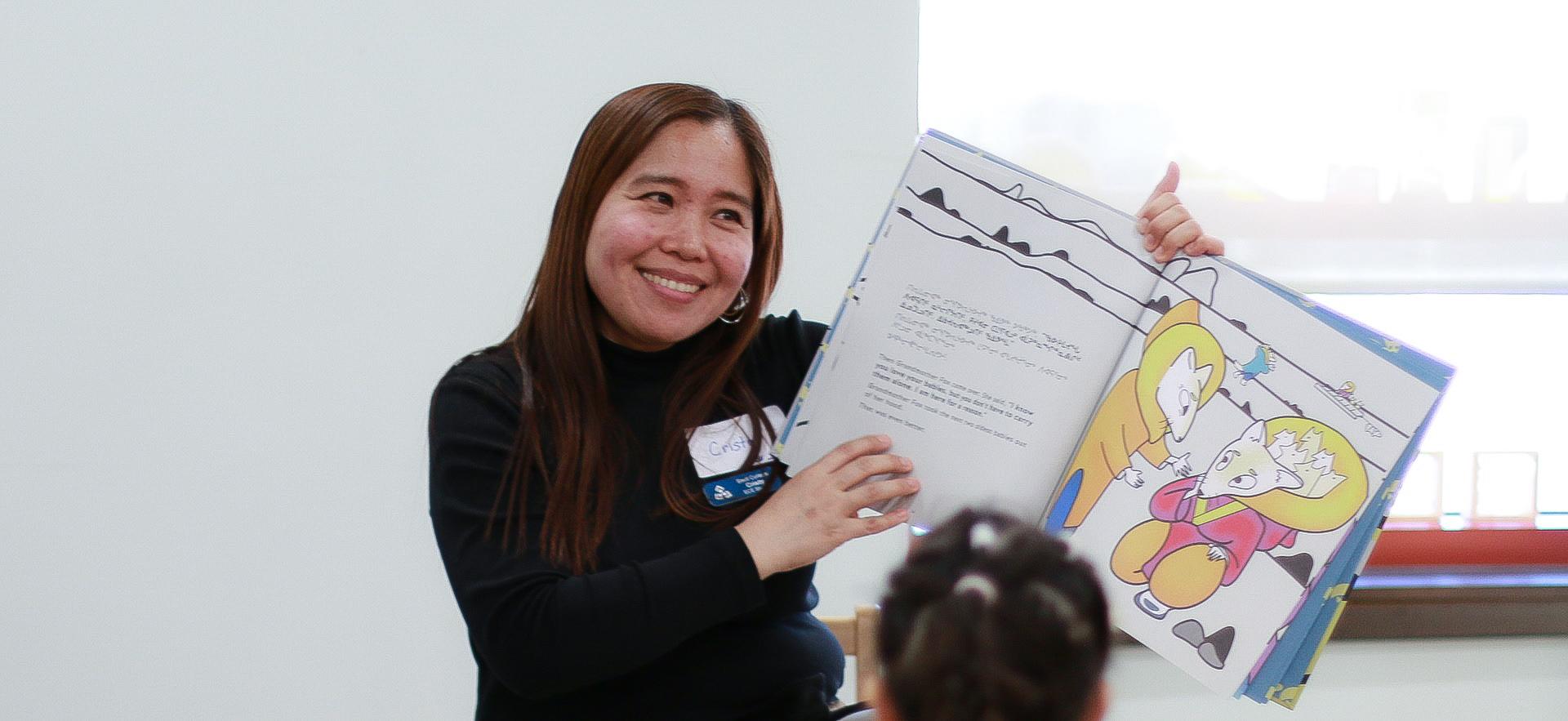 ECE student reading a book to children
