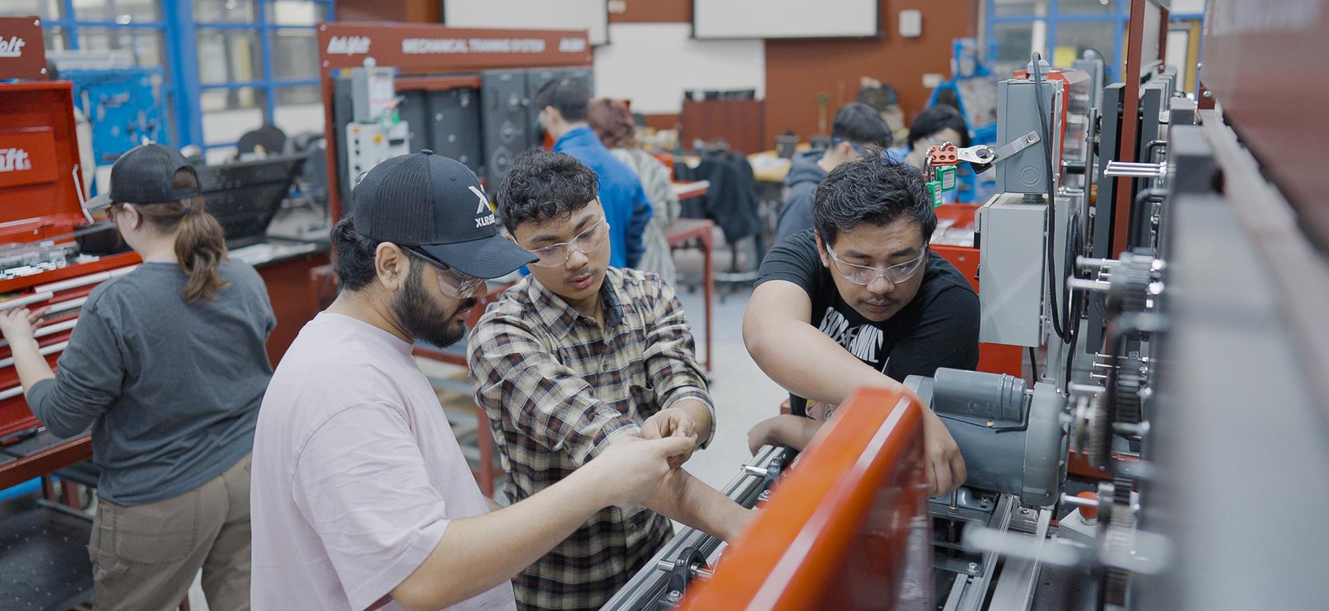 Mechanical Engineering students working with equipment in the lab