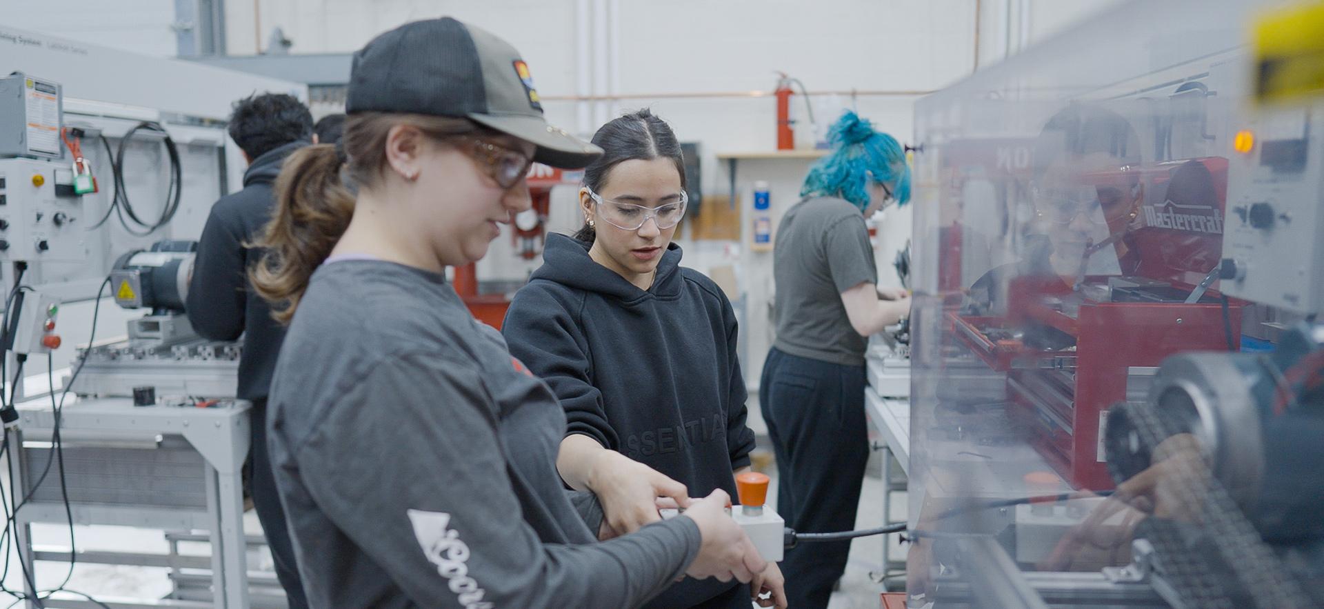 Mechanical Engineering students working with equipment in the lab
