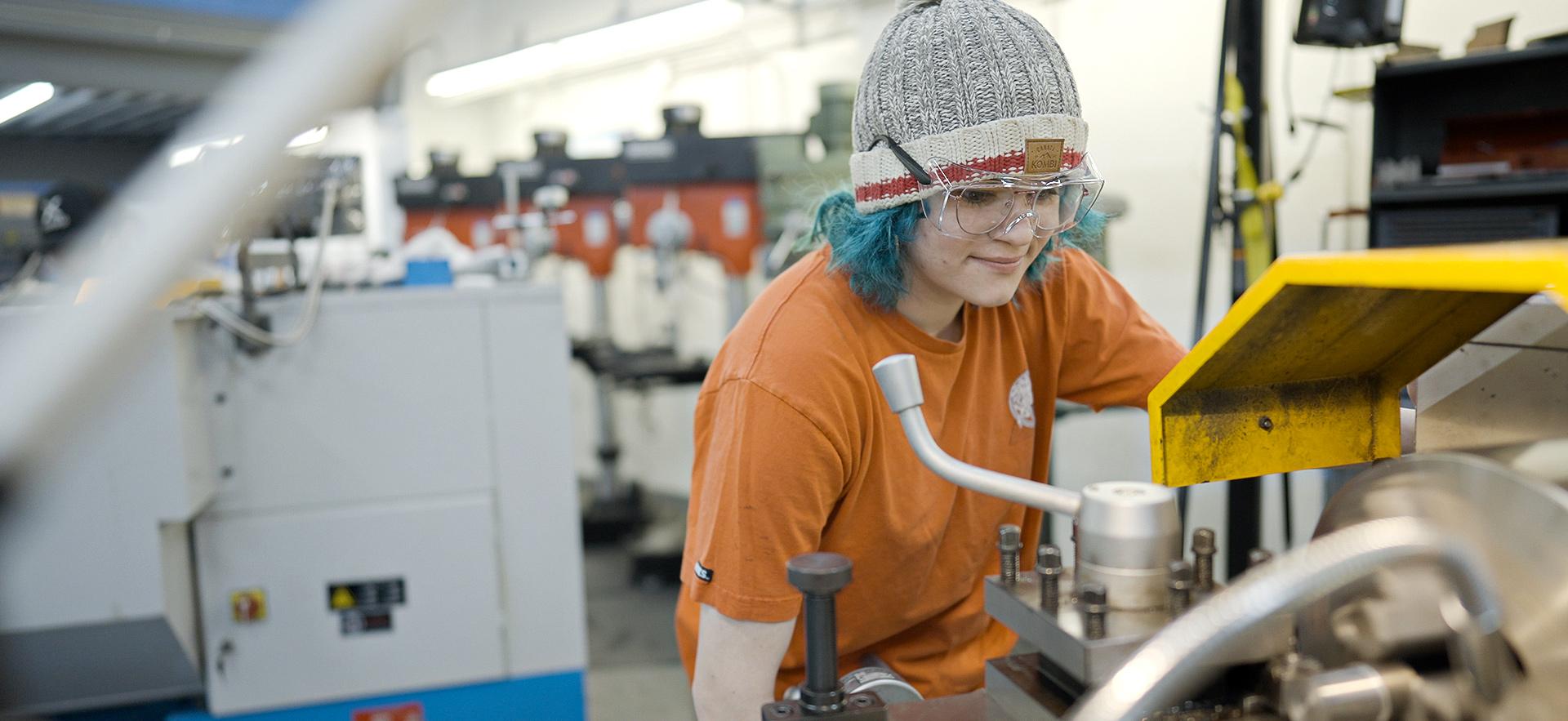 Mechanical Engineering student working with equipment in the machine shop