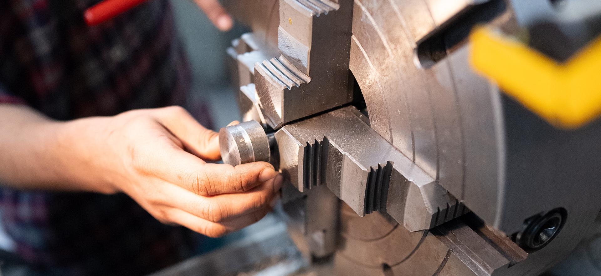 Student working with equipment in the machine shop