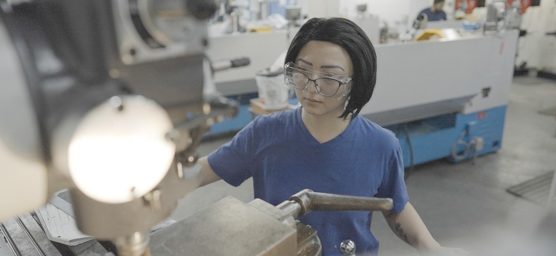 Student working with equipment in the machine shop