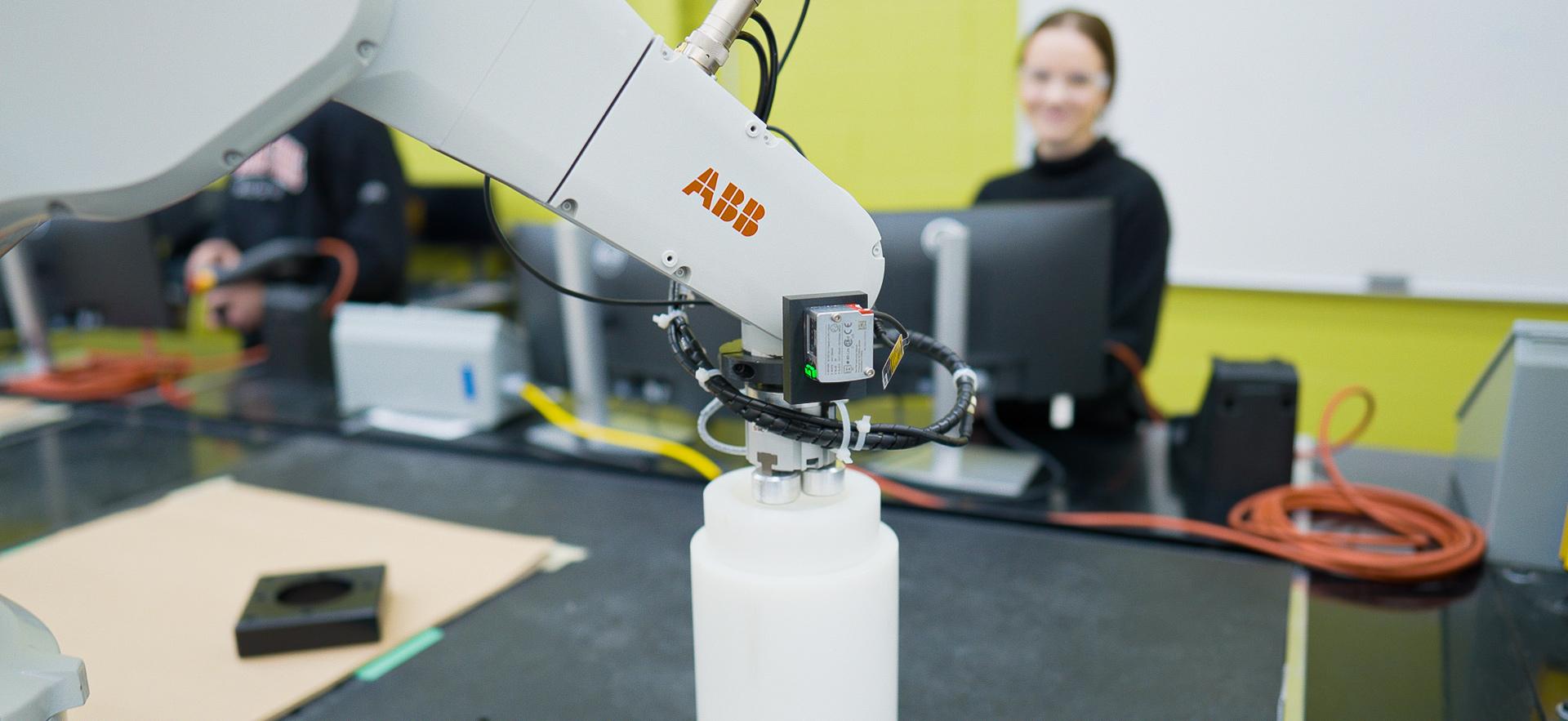 Engineering student working on computer in robotics lab