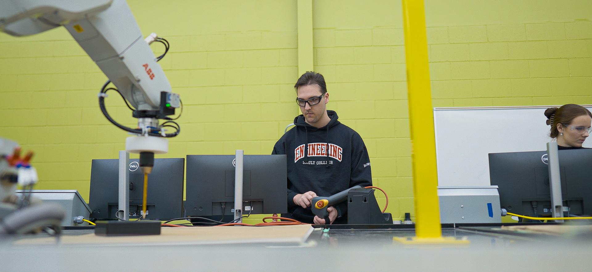Engineering student working in robotics lab