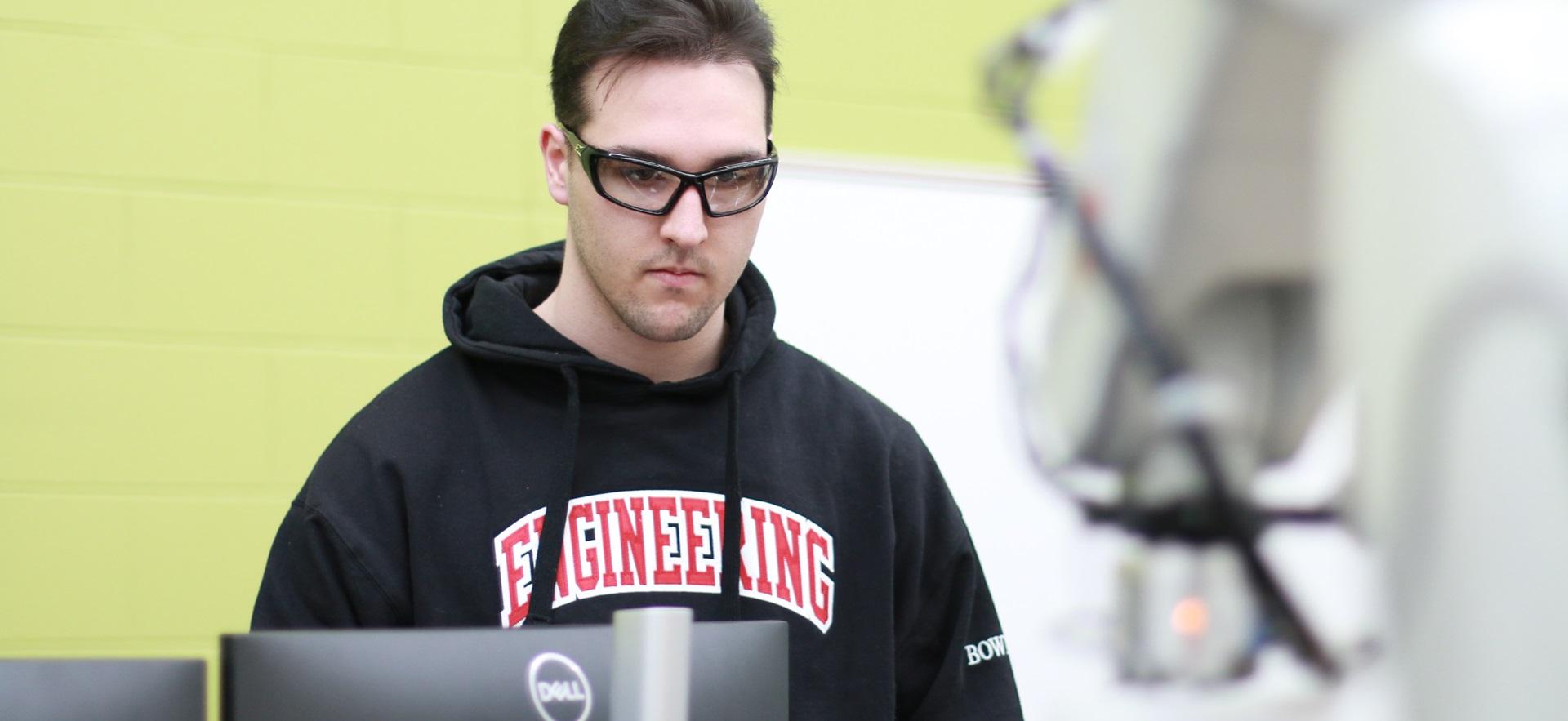 Engineering student working in robotics lab