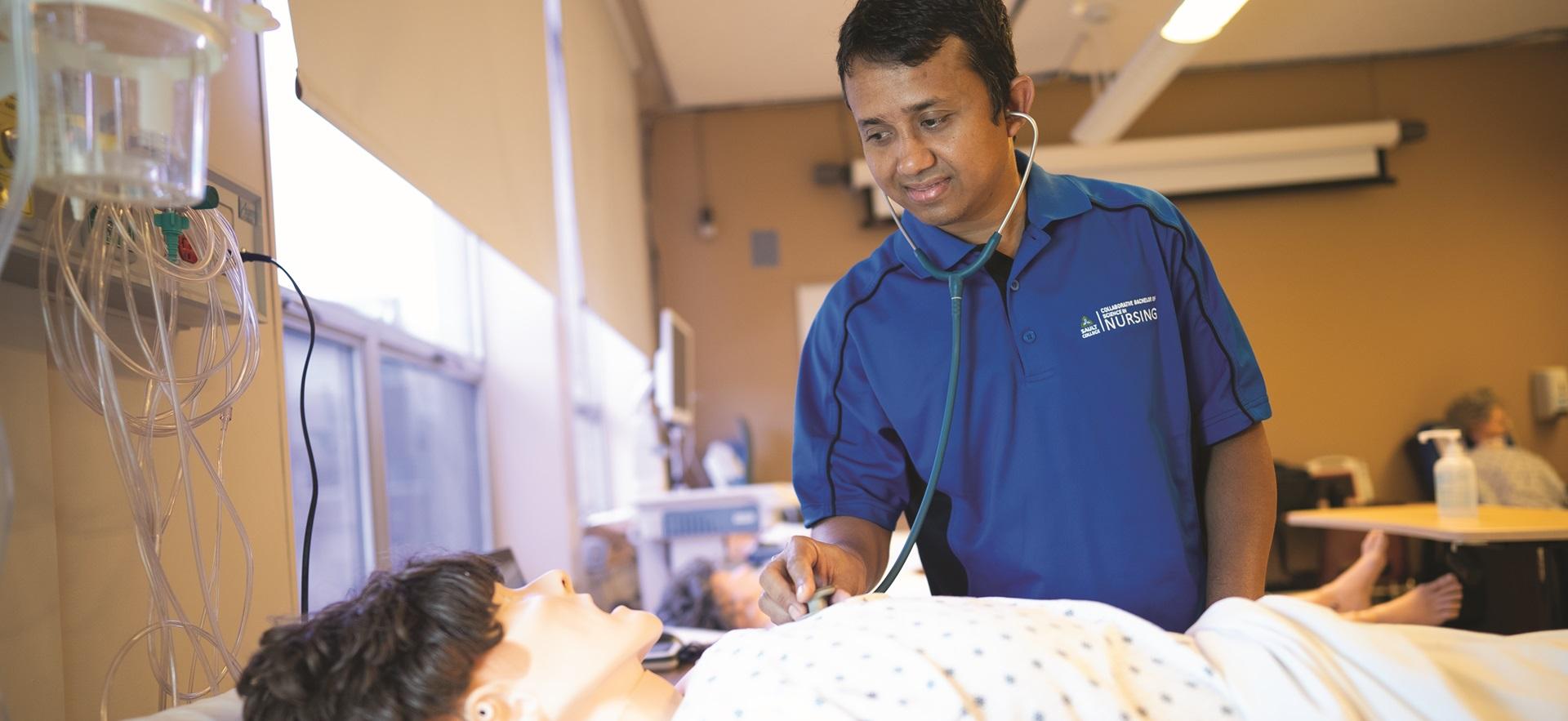 Nursing student use stethoscope to check vitals of sim