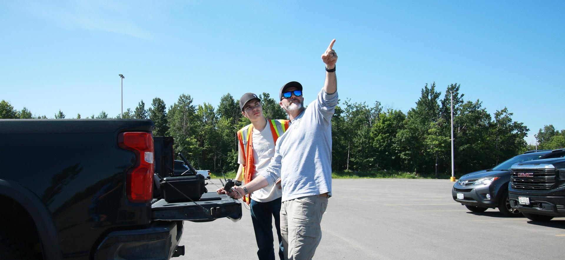 Civil Engineering student with co-op employer flying a drone