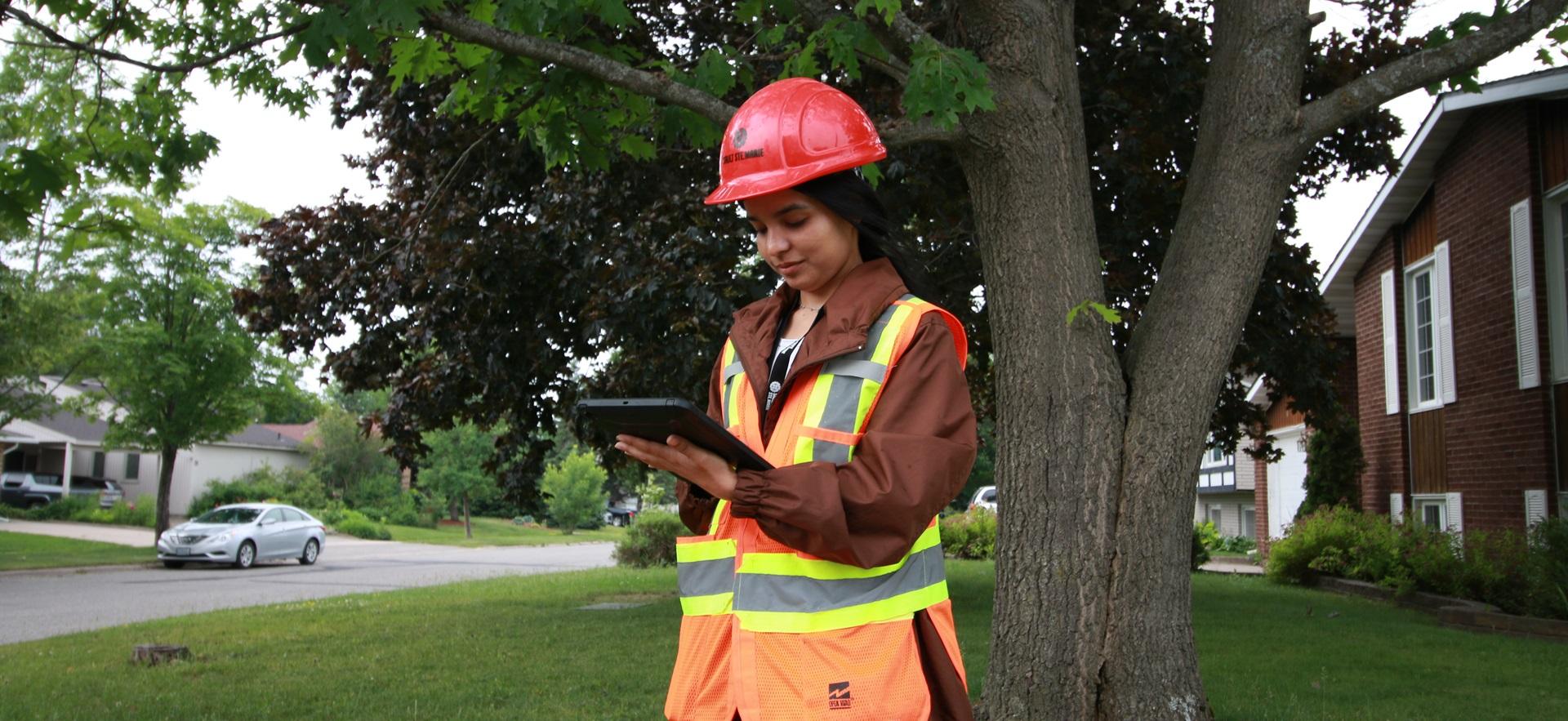 Civil Engineering student checking info on a tablet