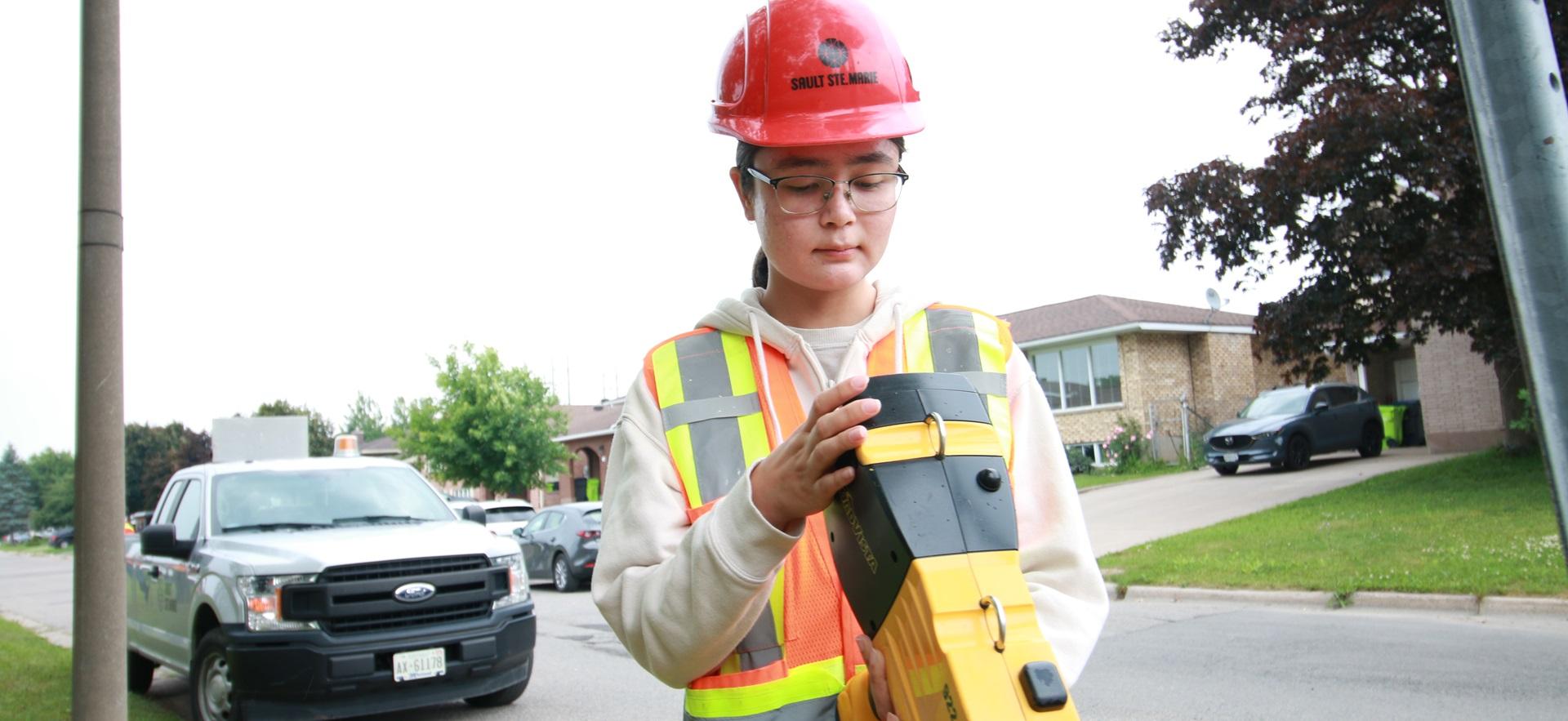 Civil Engineering student checking info on a device