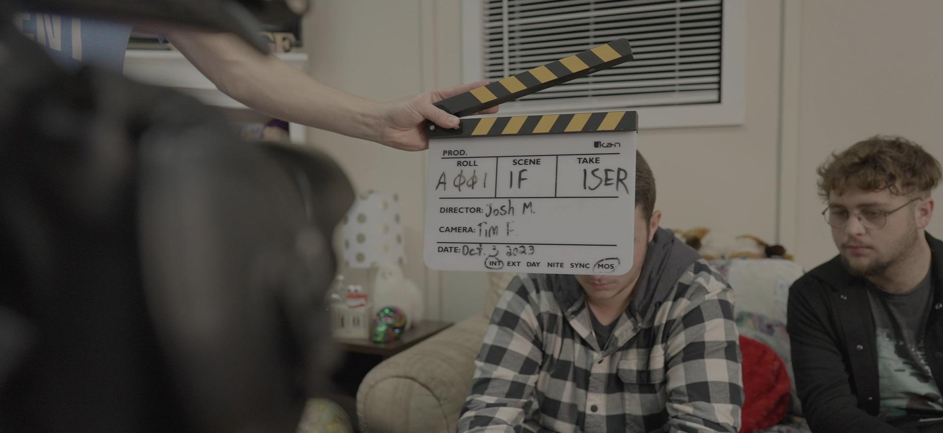 Film students shown on set as classmate records and uses clapperboard