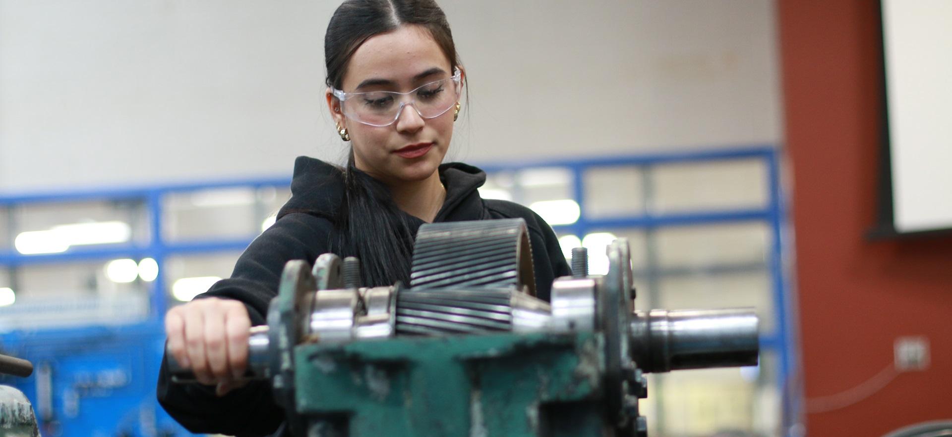 Mechanical Engineering student working with equipment in the lab
