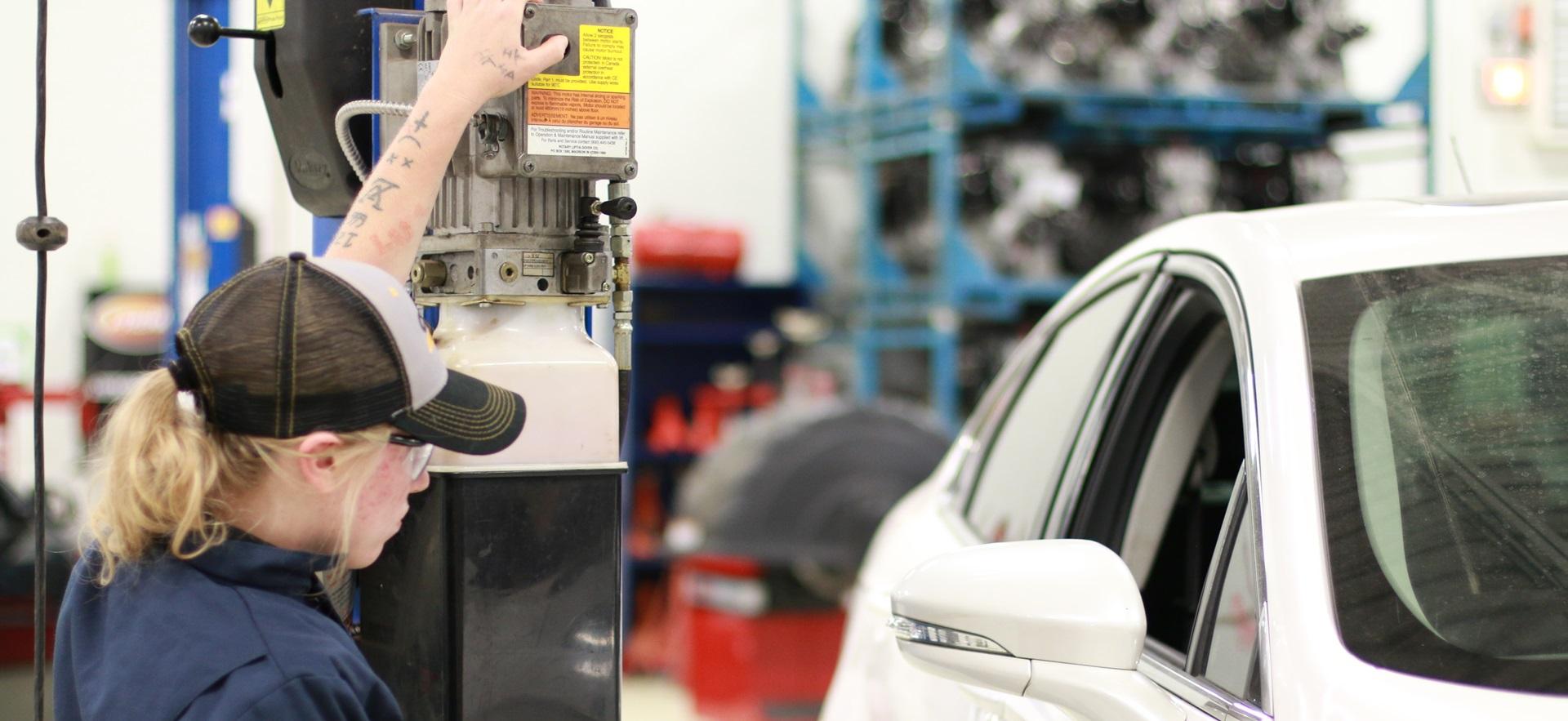 Motive Power student using car lift